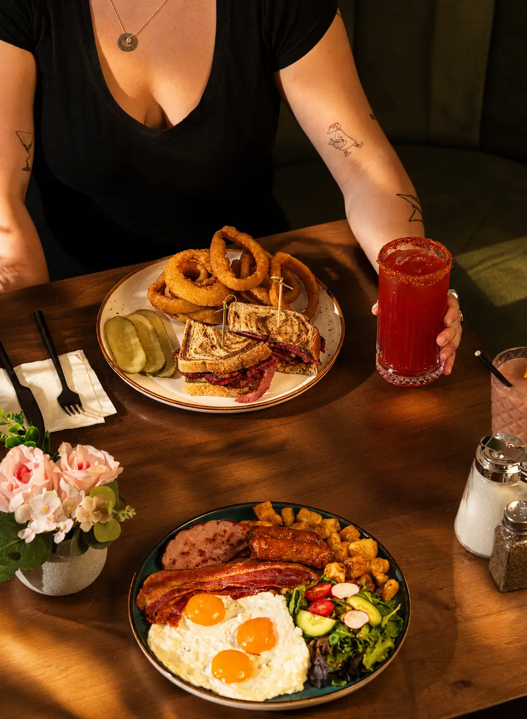 Guest with a pastrami sandwich, onion rings, big breakfast plate and a rimmed caesar at SOLENA