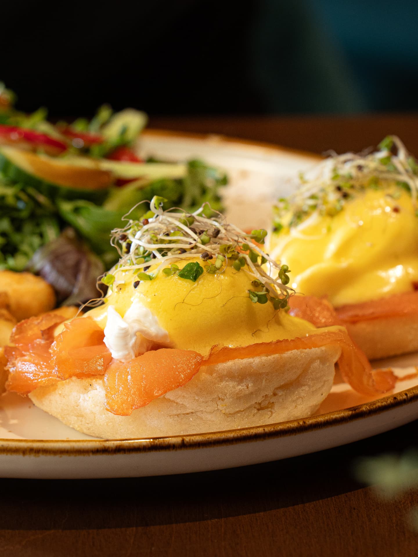 Close-up of smoked salmon benedict with hollandaise and sprouts on an English muffin at SOLENA